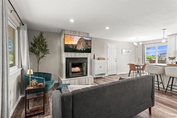 Chandelier, Dining room, Fireplace, Interior, Living room, Pendant Lights, Recessed Lighting, Wood Texture Flooring