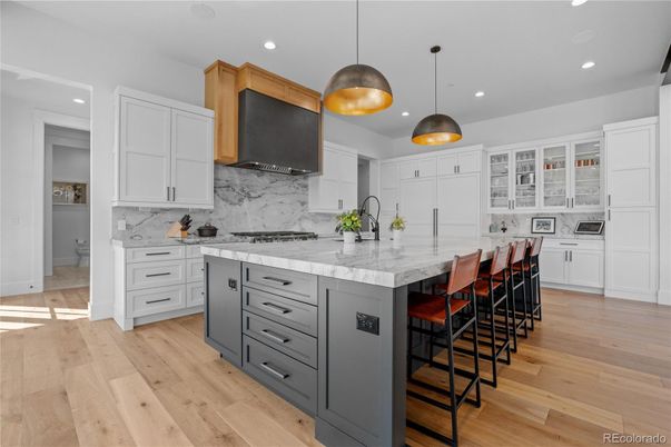 Interior, Kitchen, Marble Walls, Pendant Lights, Recessed Lighting, Stainless Steel Appliances, Wood Texture Flooring
