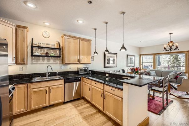 Chandelier, Interior, Kitchen, Living room, Pendant Lights, Recessed Lighting, Stainless Steel Appliances, Wood Texture Flooring