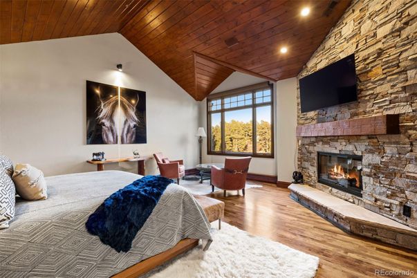 Bedroom, Fireplace, Interior, Living room, Recessed Lighting, Stone Walls, Wooden Ceilings, Wood Texture Flooring