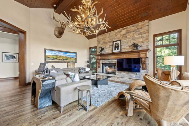Chandelier, Fireplace, Interior, Living room, Stone Walls, Wooden Beams, Wooden Ceilings, Wood Texture Flooring