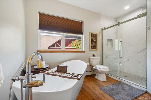 Bathroom, Free Standing Baths, Glass Shower, Interior, Marble Walls, Recessed Lighting, Wood Texture Flooring