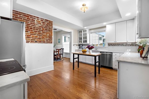 Dining room, Interior, Kitchen, Recessed Lighting, Stainless Steel Appliances, Stone Walls, Wood Texture Flooring