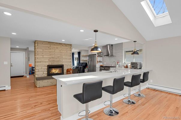 Fireplace, Interior, Kitchen, Pendant Lights, Recessed Lighting, Stainless Steel Appliances, Stone Walls, Wood Texture Flooring