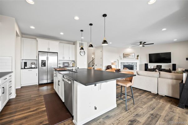 Fireplace, Interior, Kitchen, Living room, Pendant Lights, Recessed Lighting, Stainless Steel Appliances, Wood Texture Flooring