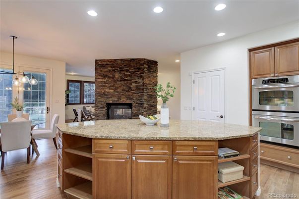 Dining room, Fireplace, Interior, Kitchen, Pendant Lights, Recessed Lighting, Stainless Steel Appliances, Stone Walls, Wood Texture Flooring