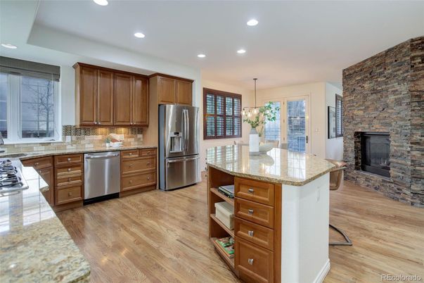 Dining room, Fireplace, Interior, Kitchen, Pendant Lights, Recessed Lighting, Stainless Steel Appliances, Stone Walls, Wood Texture Flooring