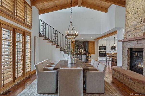 Chandelier, Dining room, Fireplace, Interior, Kitchen, Pendant Lights, Recessed Lighting, Stainless Steel Appliances, Stone Walls, Wooden Beams, Wooden Ceilings, Wood Texture Flooring
