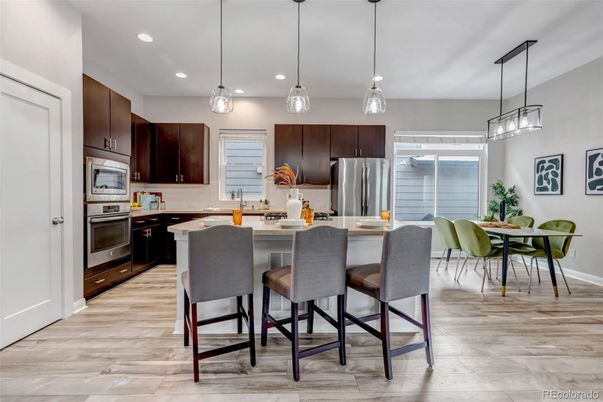 Dining room, Interior, Kitchen, Pendant Lights, Recessed Lighting, Stainless Steel Appliances, Wood Texture Flooring