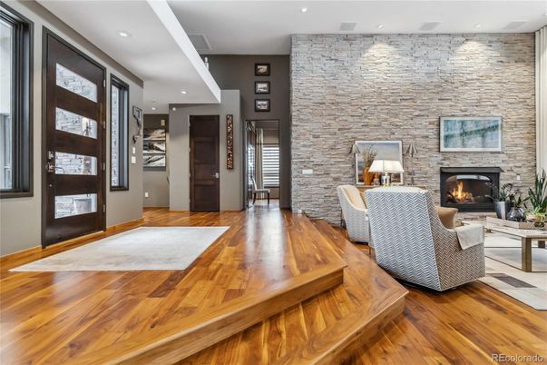 Fireplace, Interior, Living room, Recessed Lighting, Stone Walls, Wood Texture Flooring