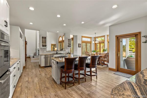 Dining room, Fireplace, Interior, Kitchen, Pendant Lights, Recessed Lighting, Stainless Steel Appliances, Wood Texture Flooring