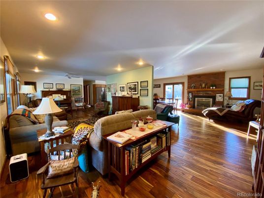 Fireplace, Interior, Living room, Recessed Lighting, Stone Walls, Wood Texture Flooring