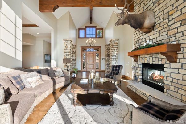 Chandelier, Fireplace, Interior, Living room, Recessed Lighting, Stone Walls, Wooden Beams, Wood Texture Flooring