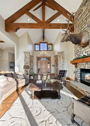 Chandelier, Fireplace, Interior, Living room, Recessed Lighting, Stone Walls, Wooden Beams, Wood Texture Flooring