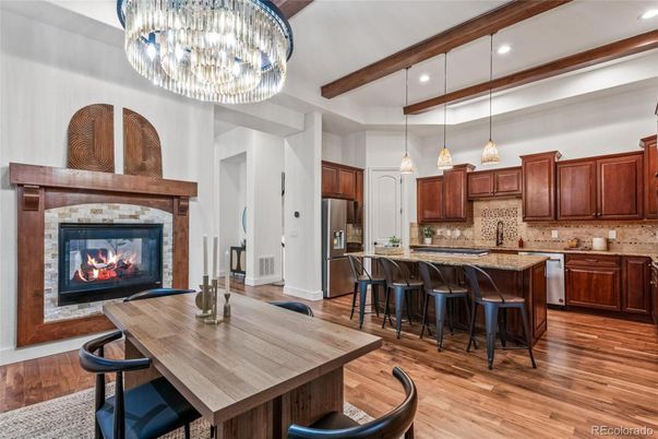 Chandelier, Dining room, Fireplace, Interior, Kitchen, Pendant Lights, Recessed Lighting, Stainless Steel Appliances, Wood Texture Flooring