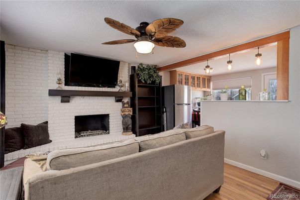 Fireplace, Interior, Kitchen, Living room, Pendant Lights, Stainless Steel Appliances, Stone Walls, Wood Texture Flooring