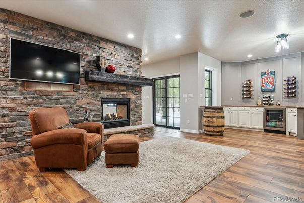 Fireplace, Interior, Living room, Recessed Lighting, Stone Walls, Wood Texture Flooring