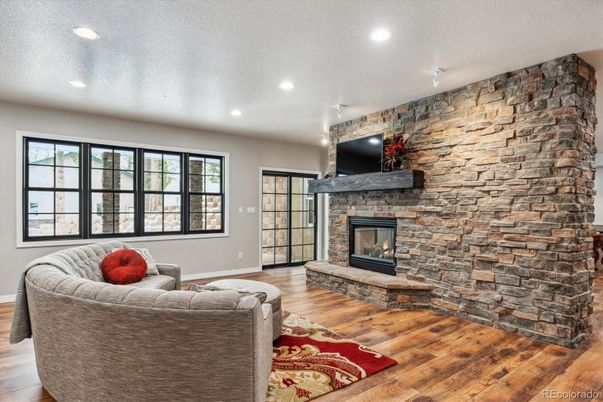 Fireplace, Interior, Living room, Recessed Lighting, Stone Walls, Wood Texture Flooring