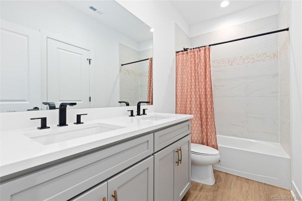 Bathroom, Dual Sink Vanities, Interior, Marble Walls, Recessed Lighting, Wood Texture Flooring