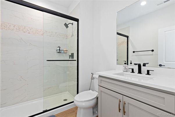 Bathroom, Glass Shower, Interior, Marble Walls, Recessed Lighting, Wood Texture Flooring