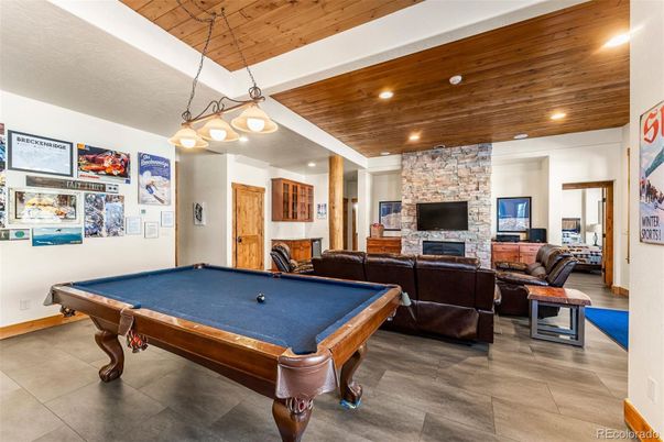 Billiard Table, Fireplace, Game Room, Interior, Living room, Pendant Lights, Recessed Lighting, Stone Walls, Wooden Ceilings