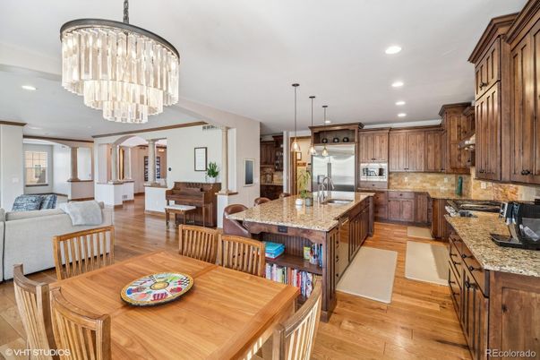 Chandelier, Dining room, Interior, Kitchen, Living room, Pendant Lights, Recessed Lighting, Stainless Steel Appliances, Wood Texture Flooring