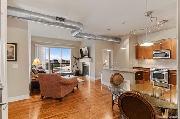 Fireplace, Interior, Kitchen, Living room, Pendant Lights, Stainless Steel Appliances, Wood Texture Flooring