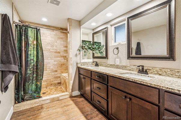 Bathroom, Dual Sink Vanities, Interior, Recessed Lighting, Stone Walls, Wood Texture Flooring