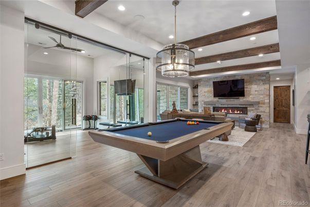 Billiard Table, Fireplace, Game Room, Interior, Pendant Lights, Recessed Lighting, Stone Walls, Wooden Beams, Wood Texture Flooring