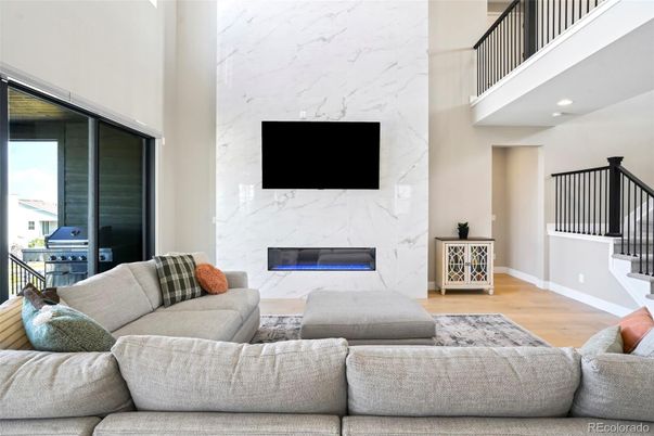 Fireplace, Interior, Living room, Marble Walls, Recessed Lighting, Wood Texture Flooring