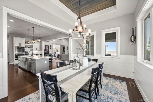 Chandelier, Dining room, Interior, Kitchen, Pendant Lights, Recessed Lighting, Stainless Steel Appliances, Wooden Ceilings, Wood Texture Flooring