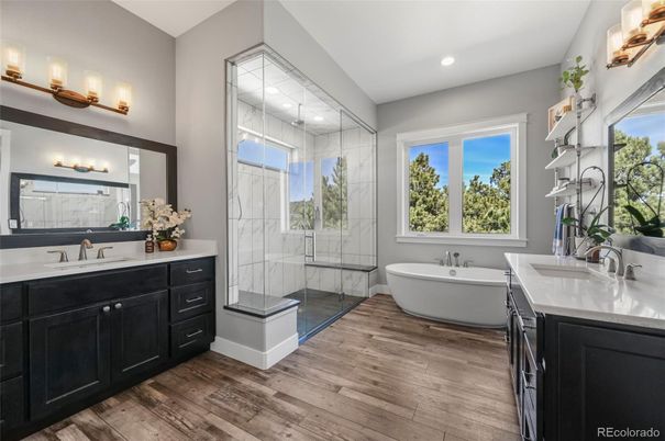 Bathroom, Dual Sink Vanities, Free Standing Baths, Glass Shower, Interior, Marble Walls, Recessed Lighting, Wood Texture Flooring