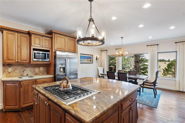 Chandelier, Dining room, Interior, Kitchen, Pendant Lights, Recessed Lighting, Stainless Steel Appliances, Wood Texture Flooring