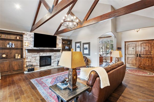 Chandelier, Fireplace, Interior, Living room, Stone Walls, Wooden Beams, Wood Texture Flooring