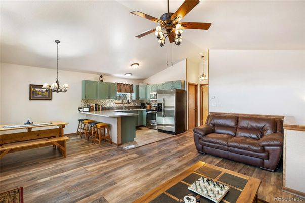 Chandelier, Dining room, Interior, Kitchen, Pendant Lights, Stainless Steel Appliances, Wood Texture Flooring