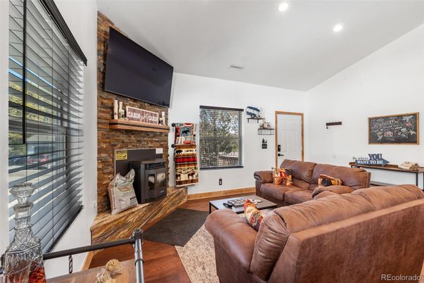 Fireplace, Interior, Living room, Recessed Lighting, Stone Walls, Wood Texture Flooring