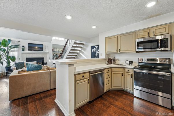 Fireplace, Interior, Kitchen, Living room, Recessed Lighting, Stainless Steel Appliances, Wood Texture Flooring