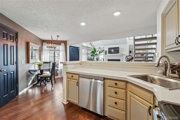 Chandelier, Dining room, Fireplace, Interior, Kitchen, Recessed Lighting, Stainless Steel Appliances, Wood Texture Flooring