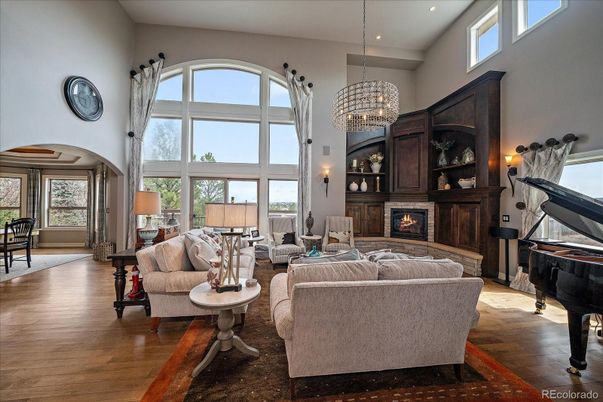 Chandelier, Fireplace, Interior, Living room, Piano, Recessed Lighting, Wood Texture Flooring