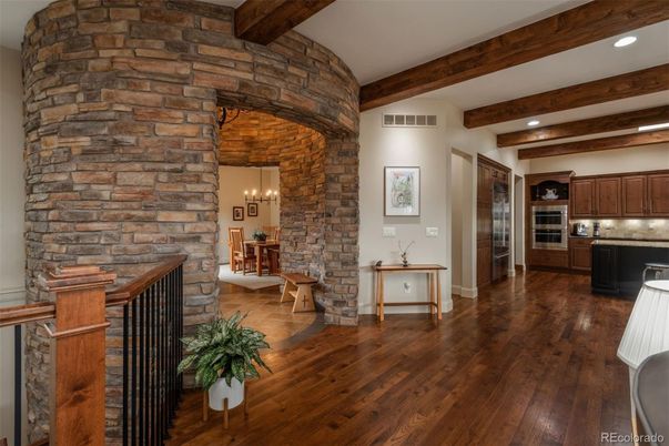 Chandelier, Dining room, Interior, Kitchen, Pendant Lights, Recessed Lighting, Stainless Steel Appliances, Stone Walls, Wooden Beams, Wood Texture Flooring