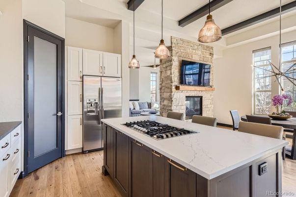 Dining room, Fireplace, Interior, Kitchen, Pendant Lights, Stainless Steel Appliances, Stone Walls, Wood Texture Flooring