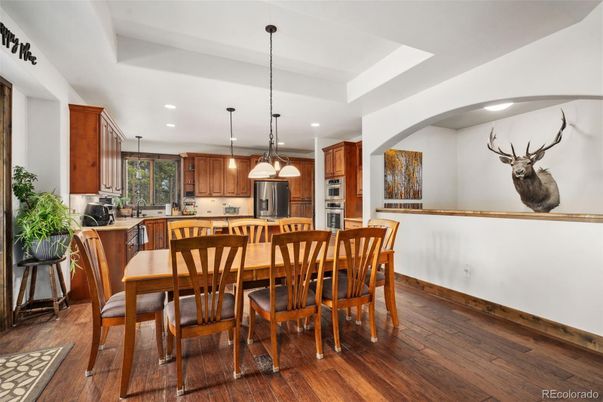 Dining room, Interior, Kitchen, Pendant Lights, Recessed Lighting, Stainless Steel Appliances, Wood Texture Flooring
