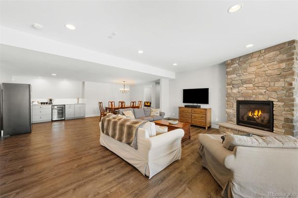 Chandelier, Dining room, Fireplace, Interior, Kitchen, Living room, Recessed Lighting, Stone Walls, Wood Texture Flooring