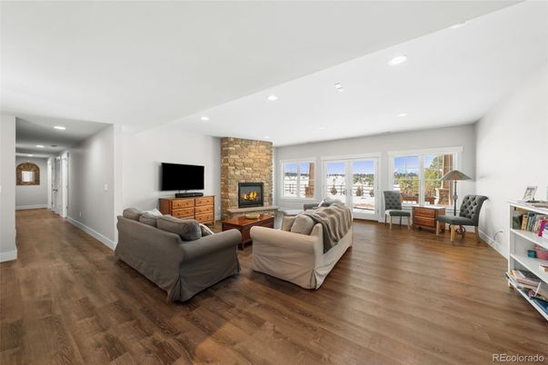 Fireplace, Interior, Living room, Recessed Lighting, Stone Walls, Wood Texture Flooring