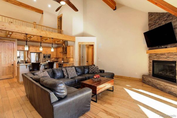 Fireplace, Interior, Kitchen, Living room, Pendant Lights, Recessed Lighting, Stainless Steel Appliances, Stone Walls, Wooden Beams, Wood Texture Flooring