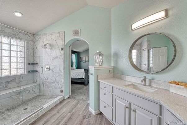 Bathroom, Bedroom, Dual Sink Vanities, Glass Shower, Interior, Marble Walls, Recessed Lighting, Wood Texture Flooring