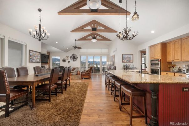 Chandelier, Dining room, Interior, Kitchen, Living room, Pendant Lights, Recessed Lighting, Stainless Steel Appliances, Wood Texture Flooring
