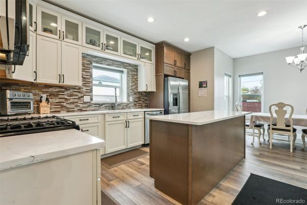 Chandelier, Dining room, Interior, Kitchen, Recessed Lighting, Stainless Steel Appliances, Wood Texture Flooring