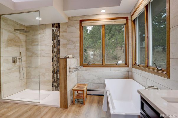 Bathroom, Free Standing Baths, Glass Shower, Interior, Marble Walls, Recessed Lighting, Wood Texture Flooring