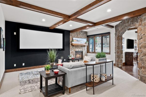 Fireplace, Interior, Living room, Projection Screen, Recessed Lighting, Stone Walls, Wooden Beams, Wood Texture Flooring